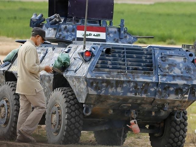 Iranian Revolutionary Guard Commander Qassem Soleimani walks near an armoured vehicle at the frontline during offensive operations against Islamic State militants in the town of Tal Ksaiba in Salahuddin province March 8, 2015. REUTERS/Stringer 