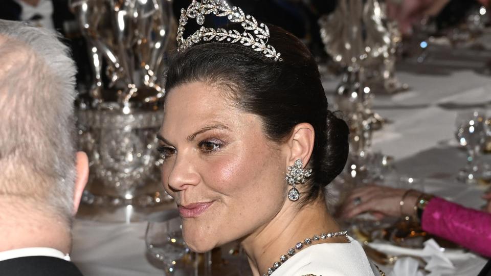 Crown Princess Victoria talking at banquet in a pair of diamond earrings to match her diamond tiara