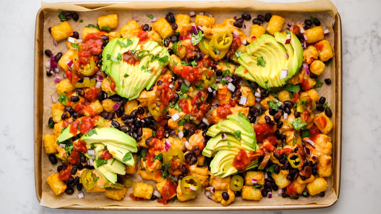 loaded tater tots on baking sheet