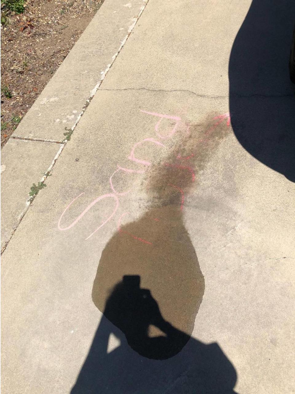 A racial slur written on the driveway of Rouble Claire’s home in Sutter, California, on May 11, 2021. Claire says a Sutter County sheriff’s deputy partially washed away the slur with his water bottle without taking any photos of the chalk as evidence. Courtesy of Rouble Claire