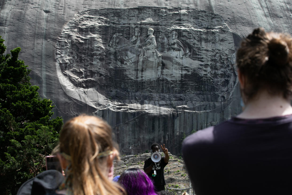 STONE MOUNTAIN, GA - JUNE 16: Organizer Quintavious Rhodes addresses Black Lives Matter protesters during a march in Stone Mountain Park to the Confederate carving etched into the stone side of the mountain on June 16, 2020 in Stone Mountain, Georgia. The march is to protest confederate monuments and recent police shootings.  Stone Mountain Park features a Confederate Memorial carving depicting Stonewall Jackson and Robert E. Lee, President Jefferson Davis.  (Photo by Jessica McGowan/Getty Images)