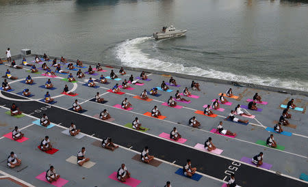Members of Indian Navy perform yoga on the flight deck of INS Viraat, an Indian Navy's decommissioned aircraft carrier during International Yoga Day in Mumbai, India, June 21, 2018. REUTERS/Francis Mascarenhas