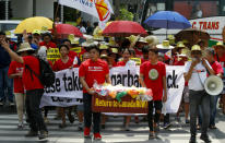 Environmentalists march outside the Canadian Embassy to demand the Canadian government to speed up the removal of several containers of garbage that were shipped to the country Tuesday, May 21, 2019, in Manila, Philippines. The Philippines recalled its ambassador and consuls in Canada last week over Ottawa's failure to comply with a deadline to take back 69 containers of garbage that Filipino officials say were illegally shipped to the Philippines years ago. (AP Photo/Bullit Marquez)