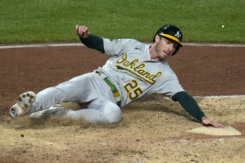 Oakland Athletics' Brent Rooker scores on a double by Aledmys Diaz off Pittsburgh Pirates relief pitcher Rob Zastryzny during the eighth inning of a baseball game in Pittsburgh, Monday, June 5, 2023. (AP Photo/Gene J. Puskar)