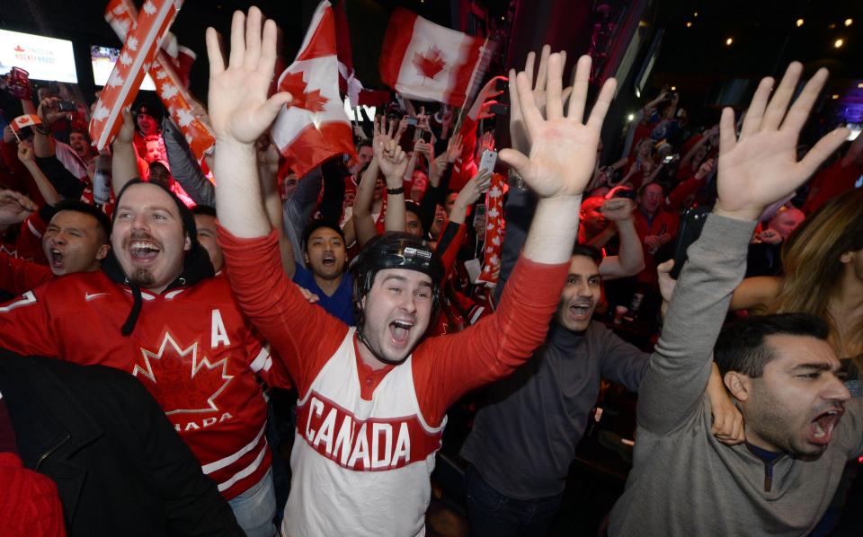 Fans celebrate Team Canada's gold medal win over Sweden in their men's ice hockey game at the Sochi 2014 Winter Olympic Games, at a gathering in Toronto February 23, 2014. REUTERS/Aaron Harris (CANADA - Tags: SPORT ICE HOCKEY OLYMPICS)