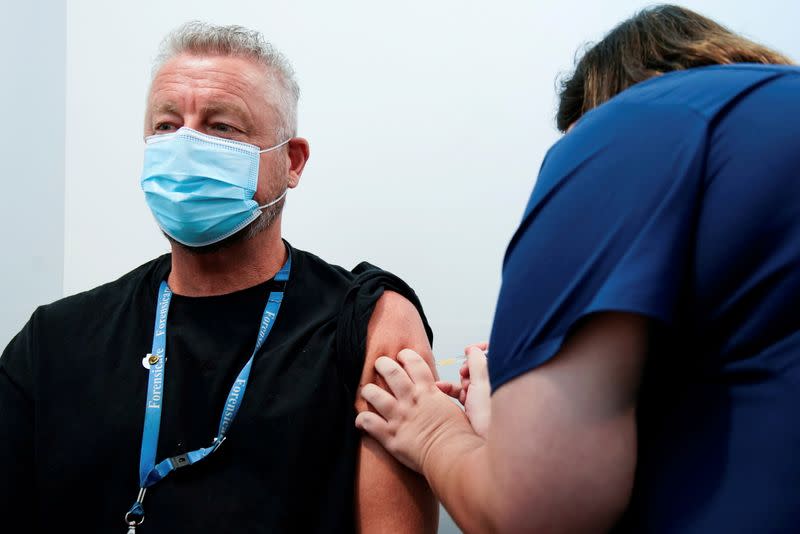 FILE PHOTO: The Pfizer COVID-19 vaccine is administered to a high-risk worker in Melbourne
