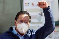 Luis Arce, Presidential candidate of the Movement to Socialism party (MAS), raises his fist after voting during Bolivia's presidential election in La Paz