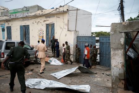 Somali government soldiers and police gather near the scene of gunfire after a suicide bomb attack outside Nasahablood hotel in Somalia's capital Mogadishu, June 25, 2016. REUTERS/Feisal Omar