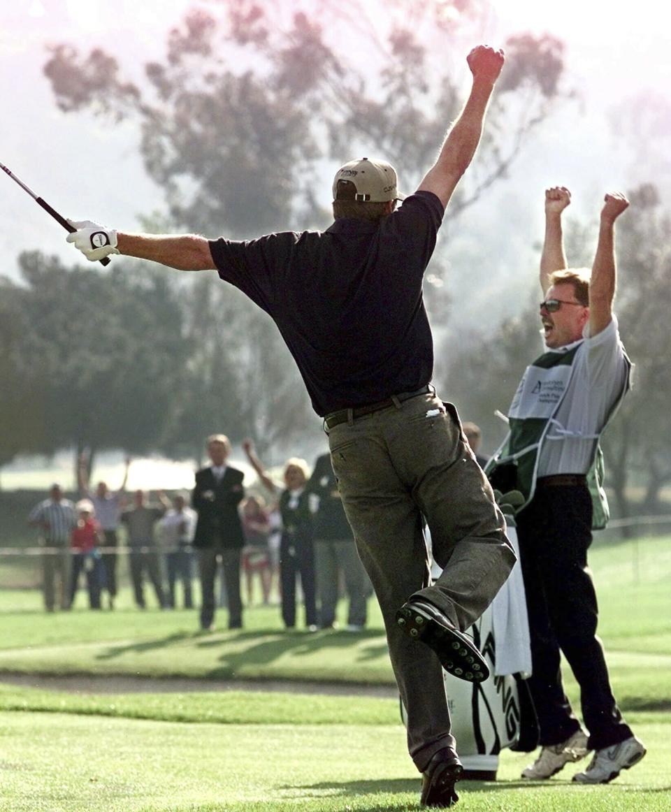 FILE -Jeff Maggert reacts, along with his caddie Bryan Sullivan, as he wins the Andersen Consulting Match Play Championship at La Costa Resort and Spa, Sunday, Feb. 28, 1999, in Carlsbad, Calif. Maggert won over Andrew Magee on the second hole of sudden death. That was the first Match Play. This year in Austin, Texas, marks the last one. (AP Photo/Mark J. Terrill, File)