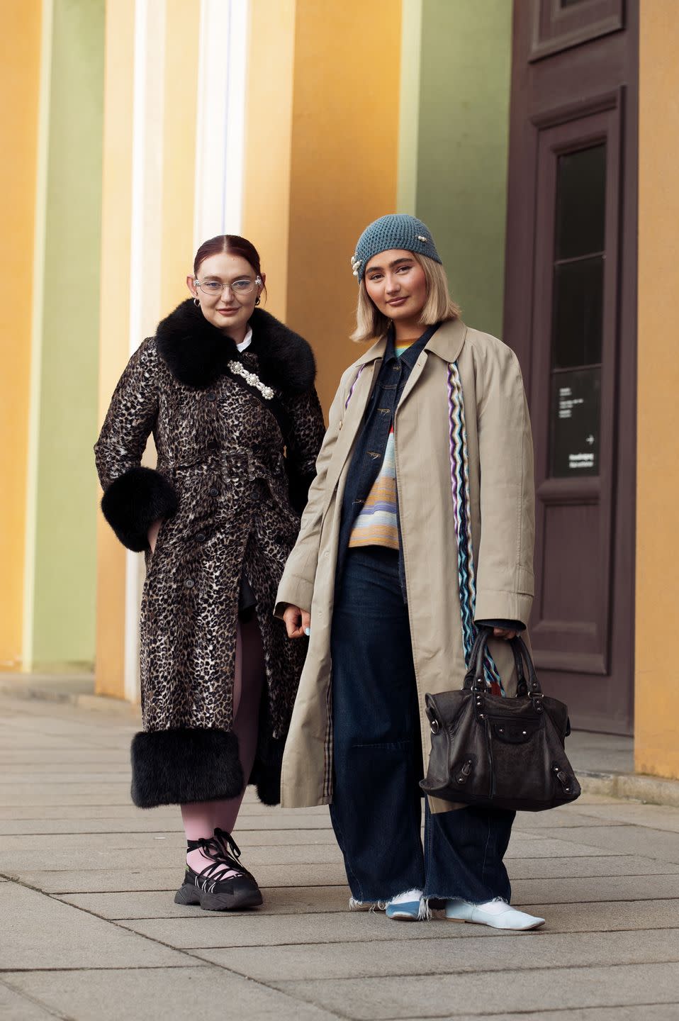 copenhagen, denmark january 29 a guest is wearing pink tights, black shoes, and an animal print coat and a guest is wearing wide dark blue pants and, a beige trench coat, black bag and blue hat during the copenhagen fashion week aw24 on january 29, 2024 in copenhagen, denmark photo by raimonda kulikauskienegetty images