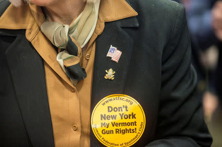 FILE PHOTO: State Representative Mary Morrissey of Bennington County, wears a sticker stating "Don't New York My Vermont Gun Rights" as she mingles at the annual Sportsmen's Legislative Mixer in Montpelier, Vermont, U.S., March 13, 2018. REUTERS/Christinne Muschi/File Photo