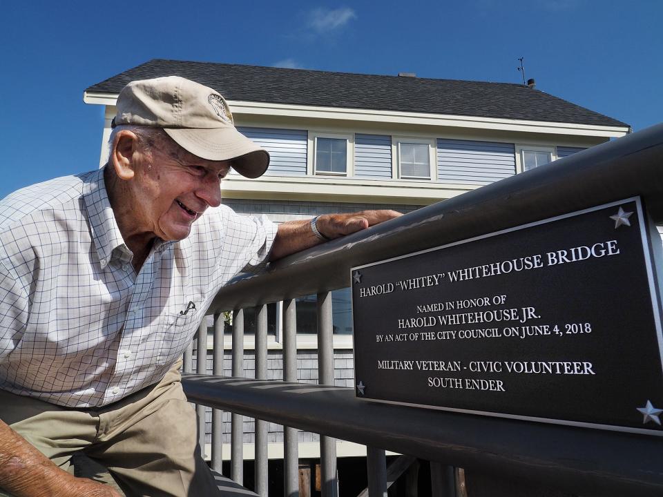 Pictured at 90 in 2018, longtime South End resident Harold Whitehouse reads a plaque placed on the South Street Mill Pond bridge in Portsmouth that was officially renamed to the Harold "Whitey" Whitehouse Bridge.