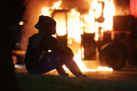 Aug 23, 2020; Kenosha, WI, USA; A man watches as a city truck is on fire outside the Kenosha County Courthouse in Kenosha on Sunday, Aug. 23, 2020. Kenosha police shot a man Sunday evening, setting off unrest in the city after a video appeared to show the officer firing several shots at close range into the man's back. Mandatory Credit: Mike De Sisti/Milwaukee Journal Sentinel via USA TODAY NETWORK/Sipa USA