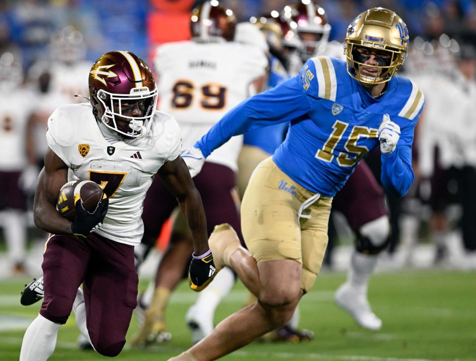 Nov 11, 2023; Pasadena, California, USA; Arizona State Sun Devils wide receiver Melquan Stovall (7) runs against UCLA Bruins defensive lineman <a class="link " href="https://sports.yahoo.com/ncaaf/players/299294/" data-i13n="sec:content-canvas;subsec:anchor_text;elm:context_link" data-ylk="slk:Laiatu Latu;sec:content-canvas;subsec:anchor_text;elm:context_link;itc:0">Laiatu Latu</a> (15) at the Rose Bowl. Mandatory Credit: Alex Gallardo-USA TODAY Sports