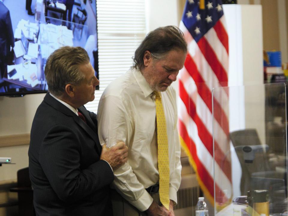 Edward Bilinkas grabs his client, Michael Barisone, as he cries in the Morris County Courthouse during his attempted murder trial in Morristown on March 30, 2022.