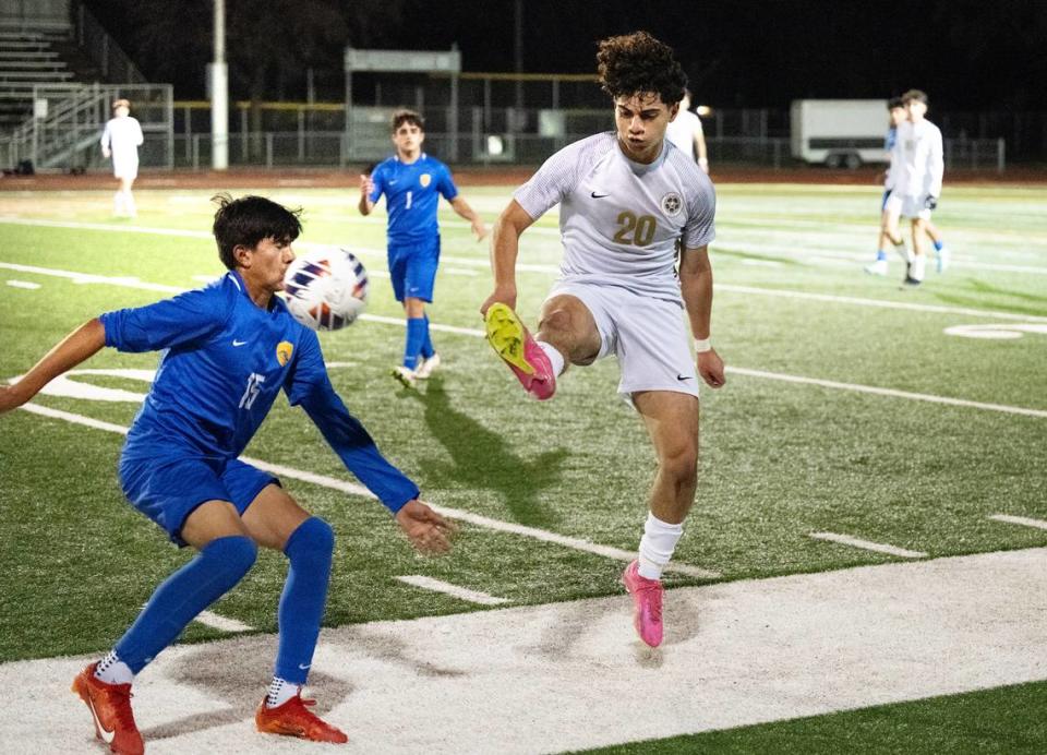 Enochs’ Diego Gonzalez (20) passes the ball forward past Turlock’s Antonio Jimenez during the Central California Athletic League game at Turlock High School in Turlock, Calif., Wednesday, Jan. 24, 2024.