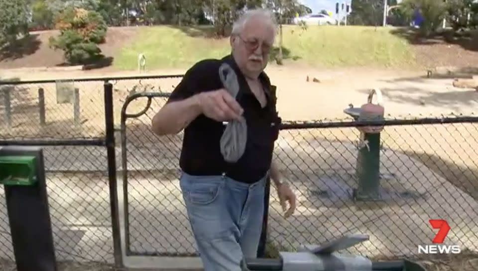 A resident does the right thing and cleans up after his dog. Source: 7 News