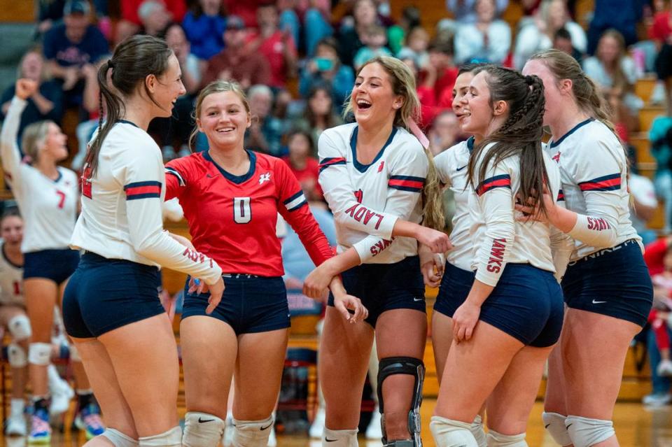 The Hancock Hawks volleyball team celebrates after a point during the 6A South State Championship game at Hancock High School in Kiln on Monday, Oct. 16, 2023.