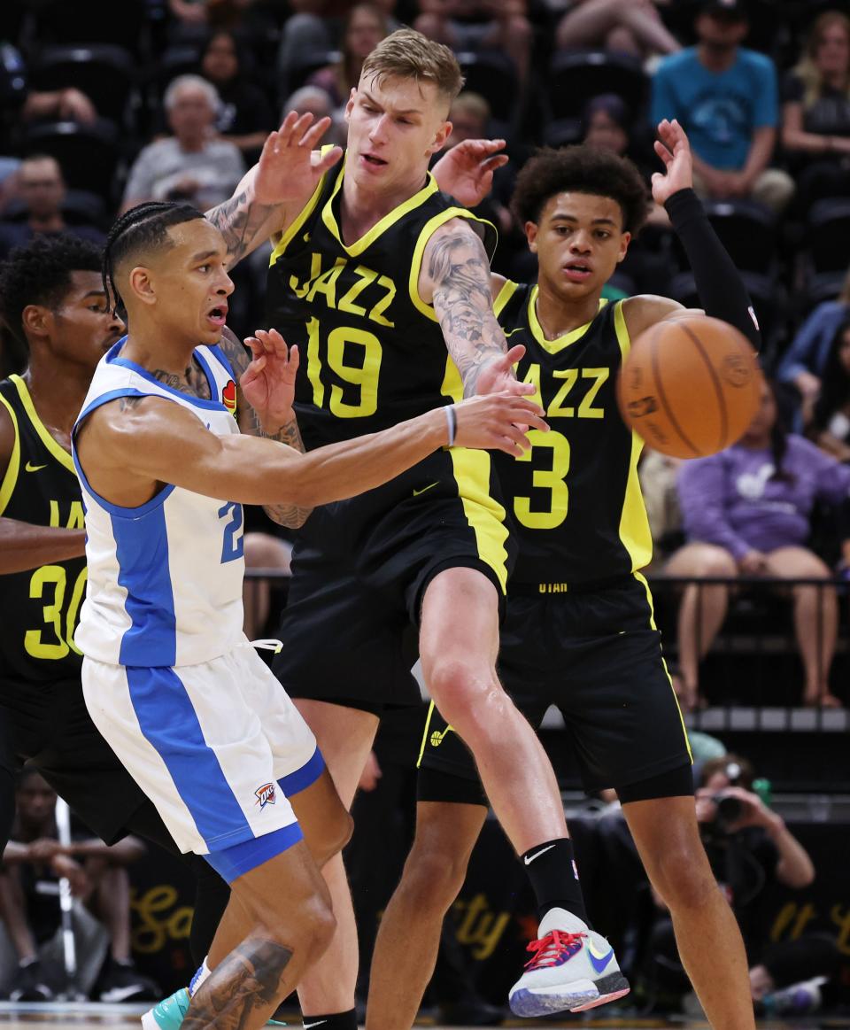 Oklahoma City’s Tre Mann passes around Utah Jazz player <a class="link " href="https://sports.yahoo.com/nba/players/6207" data-i13n="sec:content-canvas;subsec:anchor_text;elm:context_link" data-ylk="slk:Luka Samanic;sec:content-canvas;subsec:anchor_text;elm:context_link;itc:0">Luka Samanic</a> as they play in Summer League action at the Delta Center in Salt Lake City on Monday, July 3, 2023. Jazz lose 95-85. | Scott G Winterton, Deseret News