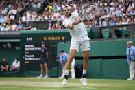 Italy's Matteo Berrettini plays a return to Poland's Hubert Hurkacz during the men's singles semifinals match on day eleven of the Wimbledon Tennis Championships in London, Friday, July 9, 2021. (AP Photo/Alberto Pezzali)