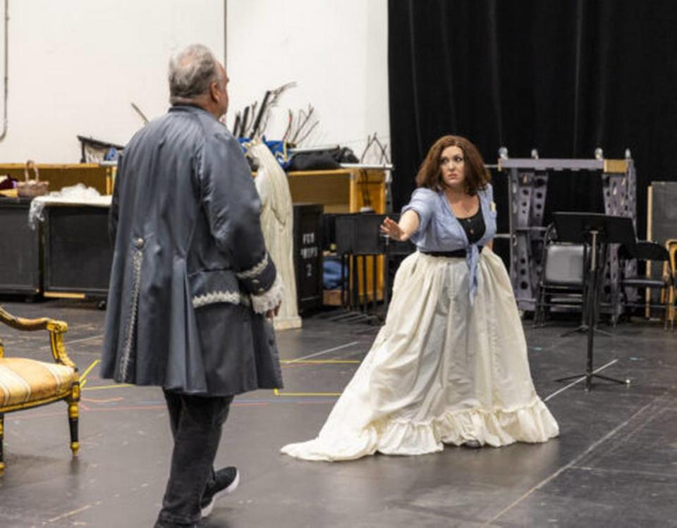 Tosca (Toni Marie Palmertree) warns Scarpia (Todd Thomas) to stay away in rehearsal for Florida Grand Opera’s “Tosca.” (Photo courtesy of Eric Joannes)