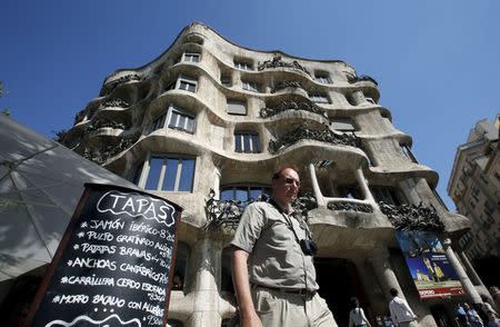 A man walks past the La Pedrera building in Barcelona, Spain in this September 13, 2013 file photo. REUTERS/Albert Gea/Files