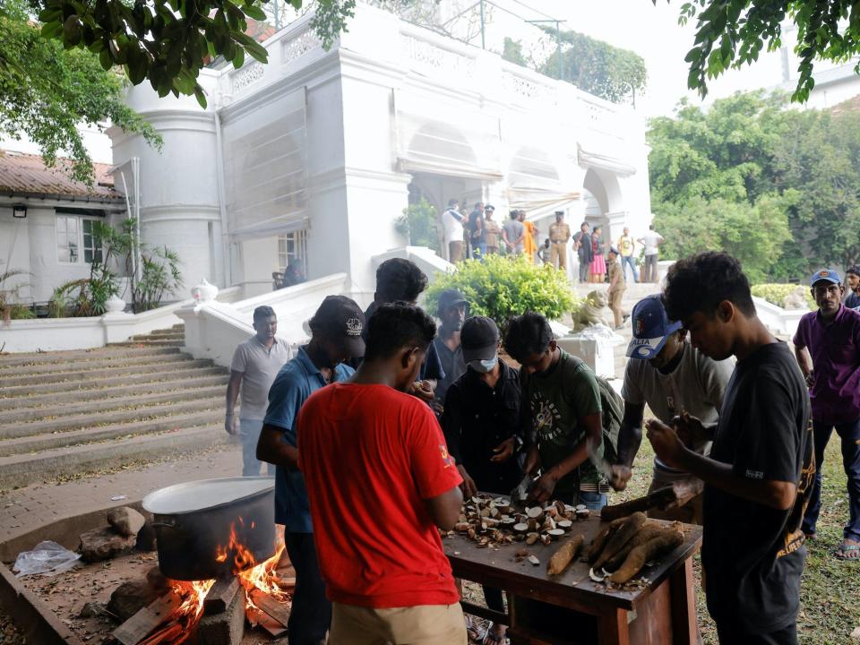 People cook in the garden of the Prime Minister's residence on the following day after demonstrators entered the building, in Colombo, Sri Lanka July 10, 2022.