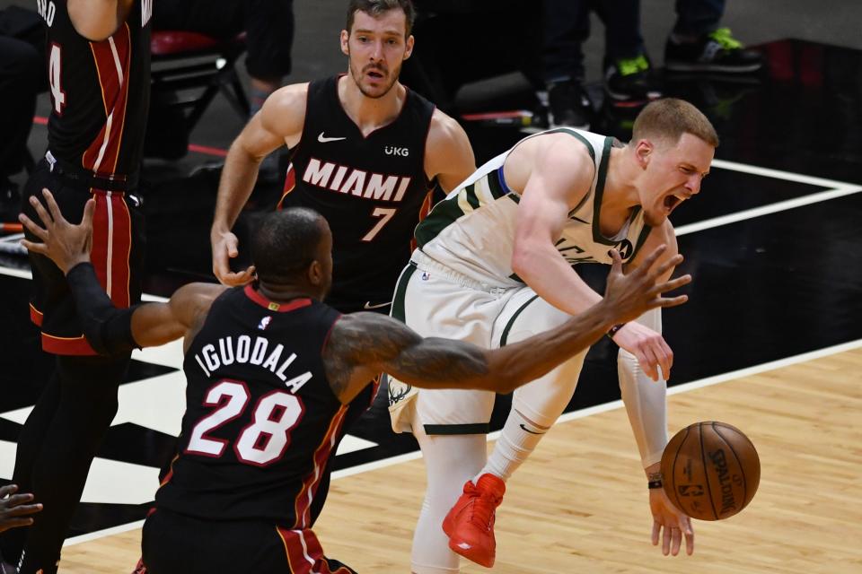 Bucks guard Donte DiVincenzo (0) gets fouled by Heat guard Goran Dragic (7) in the first half during game three in the first round of the 2021 NBA Playoffs.