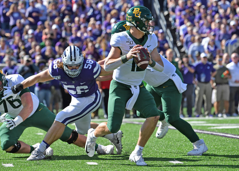 MANHATTAN, KS - OCTOBER 05:  Quarterback Charlie Brewer #12 of the Baylor Bears drops back to pass against defensive end Wyatt Hubert #56 of the Kansas State Wildcats during the first half at Bill Snyder Family Football Stadium on October 5, 2019 in Manhattan, Kansas. (Photo by Peter G. Aiken/Getty Images)