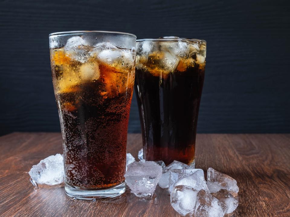 Close-up of beer glasses on table filled with cola