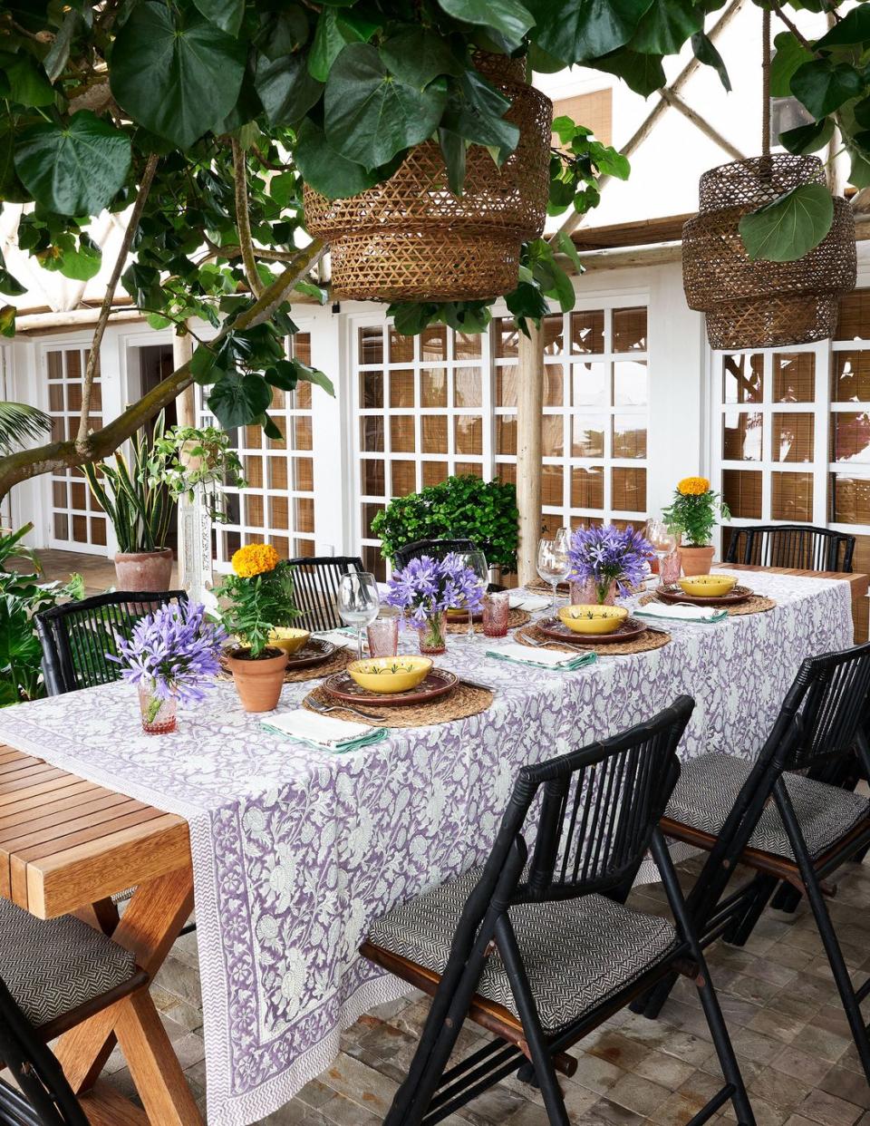 a table with chairs and plants on it