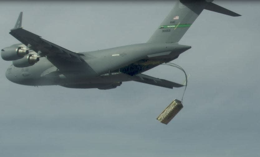 A C-17 drops palletized munitions (simulated JASSMs) during Advanced Battle Management Onramp #2 testing.