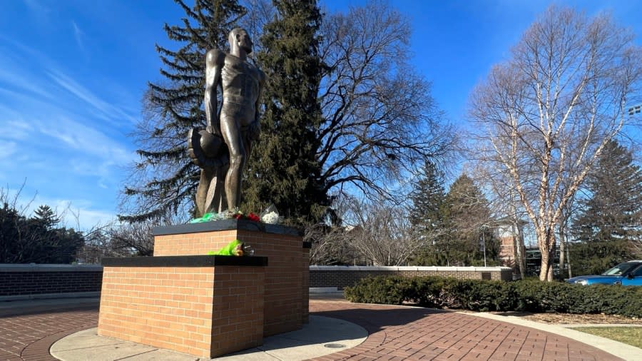 Flowers at the Spartan statue on Michigan State University the day after a shooting killed three students and injured five more. (Feb. 14, 2023)