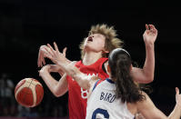 Japan's Maki Takada (8), left, is fouled by United States' Sue Bird (6) during women's basketball preliminary round game at the 2020 Summer Olympics, Friday, July 30, 2021, in Saitama, Japan. (AP Photo/Eric Gay)