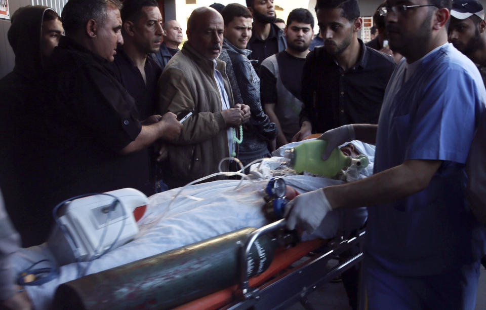 Medics and protestors move a serious wounded girl, who was shot in her head by Israeli troops during a protest at the Gaza Strip's border with Israel, into the treatment room of Shifa hospital in Gaza City, Friday, May 3, 2019. Three Palestinians, including two militants, were killed by Israeli fire Friday after gunshots from the Gaza Strip wounded two Israeli soldiers, officials said, in a new flare-up that shattered a month-long easing of hostilities that was mediated by Egypt. (AP Photo/Adel Hana)