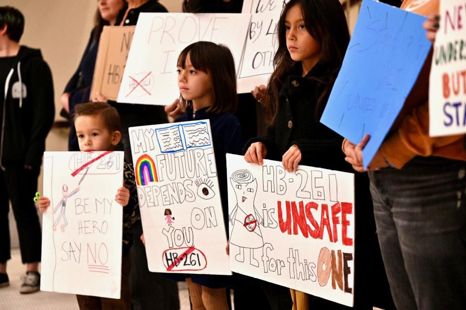 Tucker, Berkley and Kinley join their mother Kyra (no last name given) and others protesting outside the committee room against HB261 at the Capitol in Salt Lake City on Monday, Jan. 22, 2024. | Scott G Winterton, Deseret News