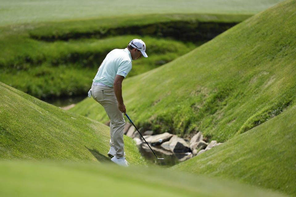 Sergio Garcia, of Spain, fishes his ball out of the creek on the 13th hole during the first round of the Masters golf tournament at Augusta National Golf Club on Thursday, April 6, 2023, in Augusta, Ga. (AP Photo/David J. Phillip)