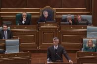 Kosovo Prime Minister Hashim Thaci, foreground, speaks during a session in Kosovo's parliament in the capital Pristina on Wednesday April 23, 2014. Kosovo's parliament voted Wednesday on a law that will enable the creation of a special war crimes tribunal staffed by international judges and prosecutors that will try alleged crimes committed by former ethnic Albanian rebels during Kosovo's 1998-99 war for independence from Serbia. (AP Photo/Visar Kryeziu)