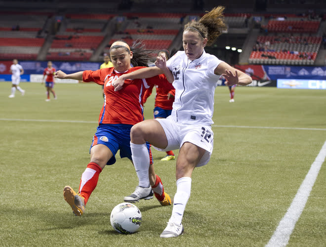 VANCOUVER, CANADA - JANUARY 27: Lauren Cheney #12 of the United States beats Wendy Acosta #20 of Costa Rica to the loose ball during the first half of semifinals action of the 2012 CONCACAF WomenÕs Olympic Qualifying Tournament at BC Place on January 27, 2012 in Vancouver, British Columbia, Canada. (Photo by Rich Lam/Getty Images)