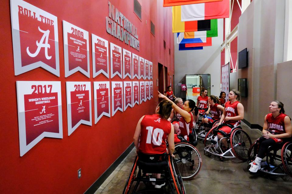 Mar 9, 2023; Tuscaloosa, AL, USA;  Alabama players look at the teamÕs heritage in all the championship banners on the wall before taking the court during media day for the WomenÕs Wheelchair Basketball National Championship Tournament at Stran-Hardin Arena.