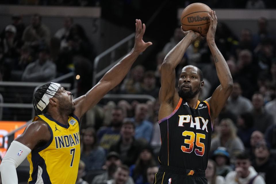 Phoenix Suns' Kevin Durant (35) shoots against Indiana Pacers' Buddy Hield during the first half of an NBA basketball game Friday, Jan. 26, 2024, in Indianapolis. (AP Photo/Darron Cummings)