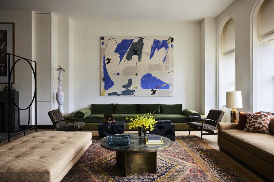 A living room with a large piece of wall art