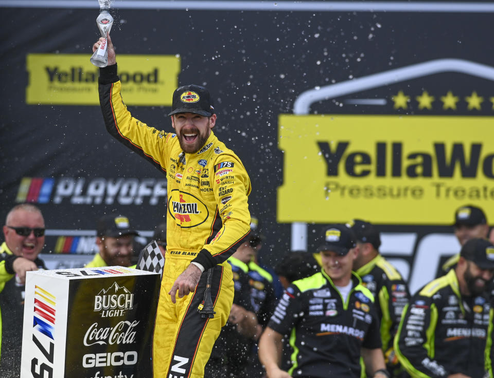 Ryan Blaney, front left, celebrates after winning a NASCAR Cup Series auto race at Talladega Superspeedway, Sunday, Oct. 1, 2023, in Talladega, Ala. (AP Photo/Julie Bennett)