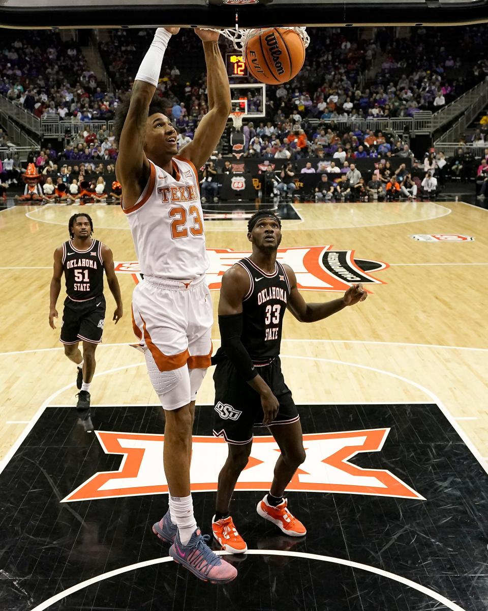 Texas forward Dillon Mitchell (23) dunks the ball during the second half of an NCAA college basketball game against Oklahoma State in the second round of the Big 12 Conference tournament Thursday, March 9, 2023, in Kansas City, Mo. (AP Photo/Charlie Riedel)