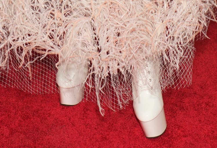 gwen stefani wears white platform high-heel boots featuring a laced-up front on the red carpet, gwen stefani red carpet shoe style, platform boots