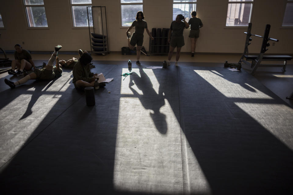 U.S. Marine Corps recruit Nicole Nomura, center, of Massachusetts, stretches before taking part in physical therapy at the rehabilitation center at the Marine Corps Recruit Depot, Wednesday, June 28, 2023, in Parris Island, S.C. (AP Photo/Stephen B. Morton)