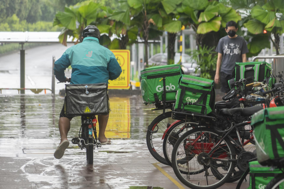 Singapore’s ride-hailing and food-delivery drivers are calling for more government protection to meet retirement and housing needs. (PHOTO: Getty Commercial)