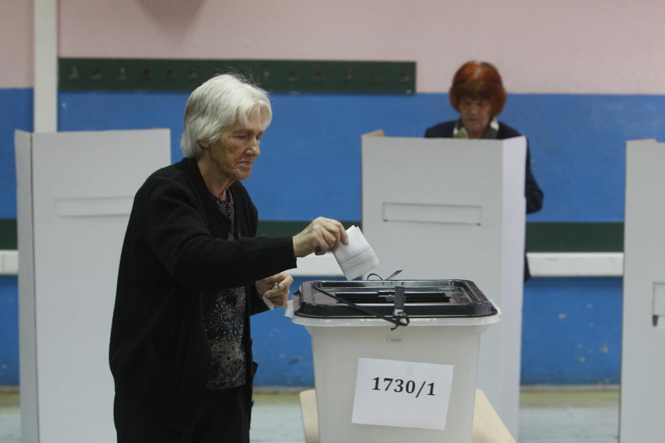 A woman casts her ballot at a polling station during a referendum in Skopje, Macedonia, Sunday, Sept. 30, 2018. Macedonians were deciding Sunday on their country's future, voting in a crucial referendum on whether to accept a landmark deal ending a decades-old dispute with neighbouring Greece by changing their country's name to North Macedonia, to qualify for NATO membership and also pave its way toward the European Union. (AP Photo/Boris Grdanoski)