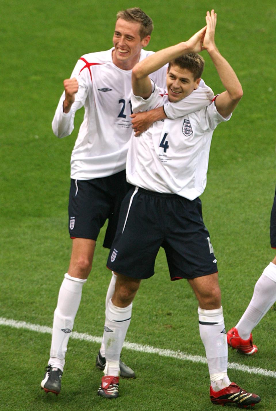 Crouch celebrates with Steven Gerrard after his Liverpool teammate got England’s crucial second goal in the same game. (PA)