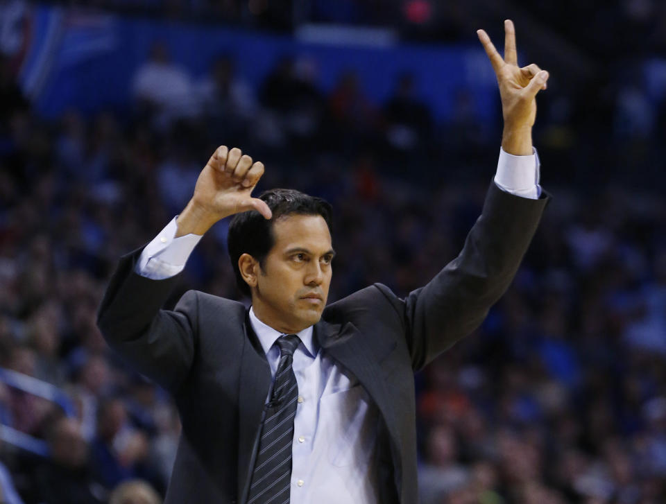 Miami Heat coach Erik Spoelstra gestures to his team during the second quarter of an NBA basketball game against the Oklahoma City Thunder in Oklahoma City, Thursday, Feb. 20, 2014. (AP Photo/Sue Ogrocki)